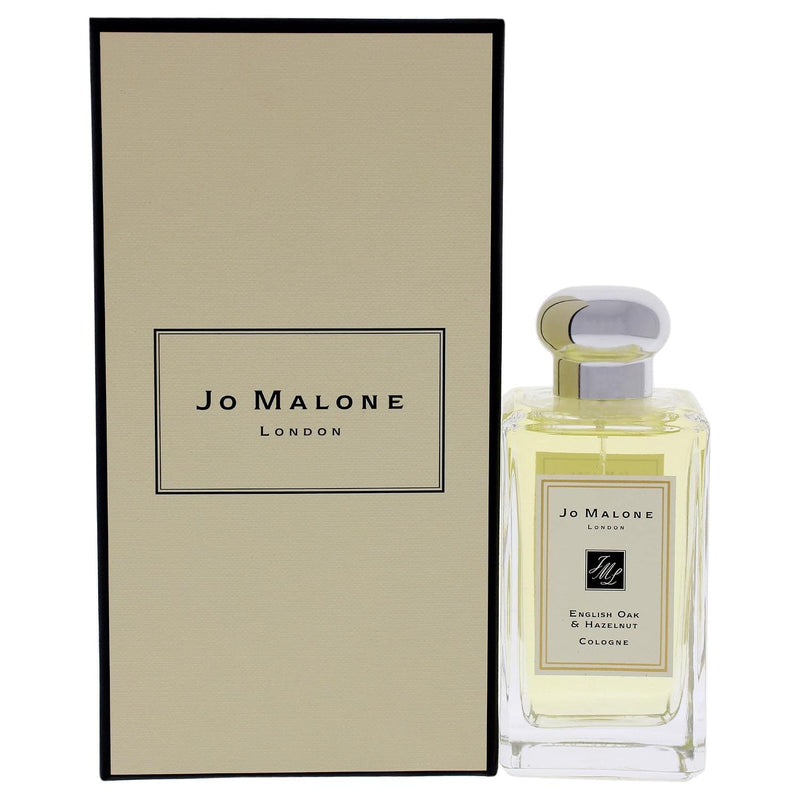 English Oak & Hazelnut by Jo Malone London — clear rectangular pale-gold fragrance bottle with silver cap and cream box